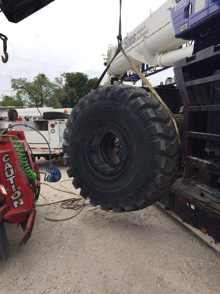 Export Logistics & Shipping, Inc. in house crane crew removes Tadano GR1000XL-5 crane tire